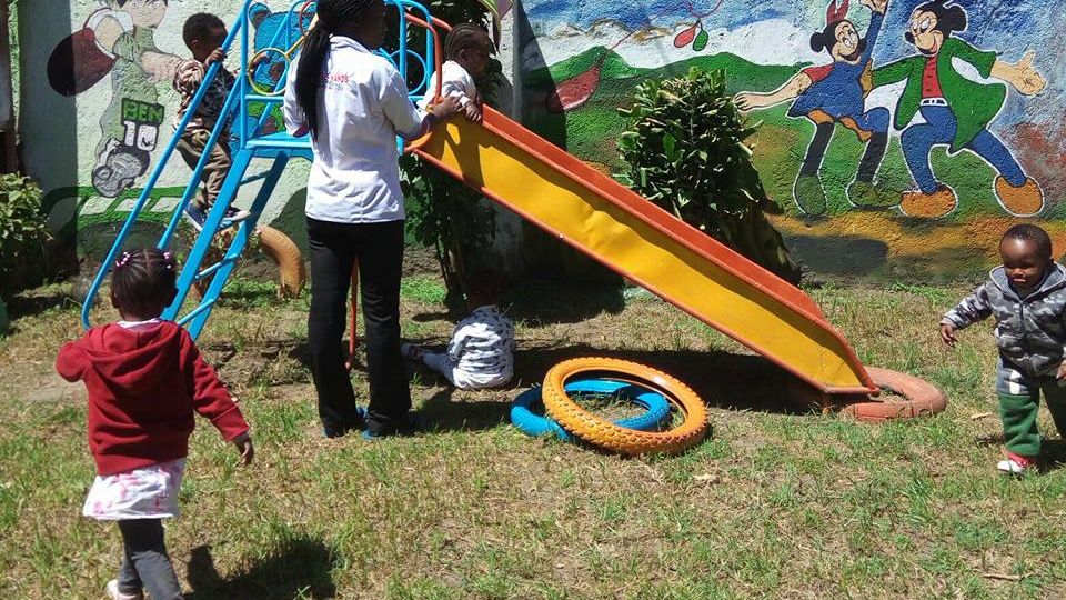 Kenyan children play on a slide