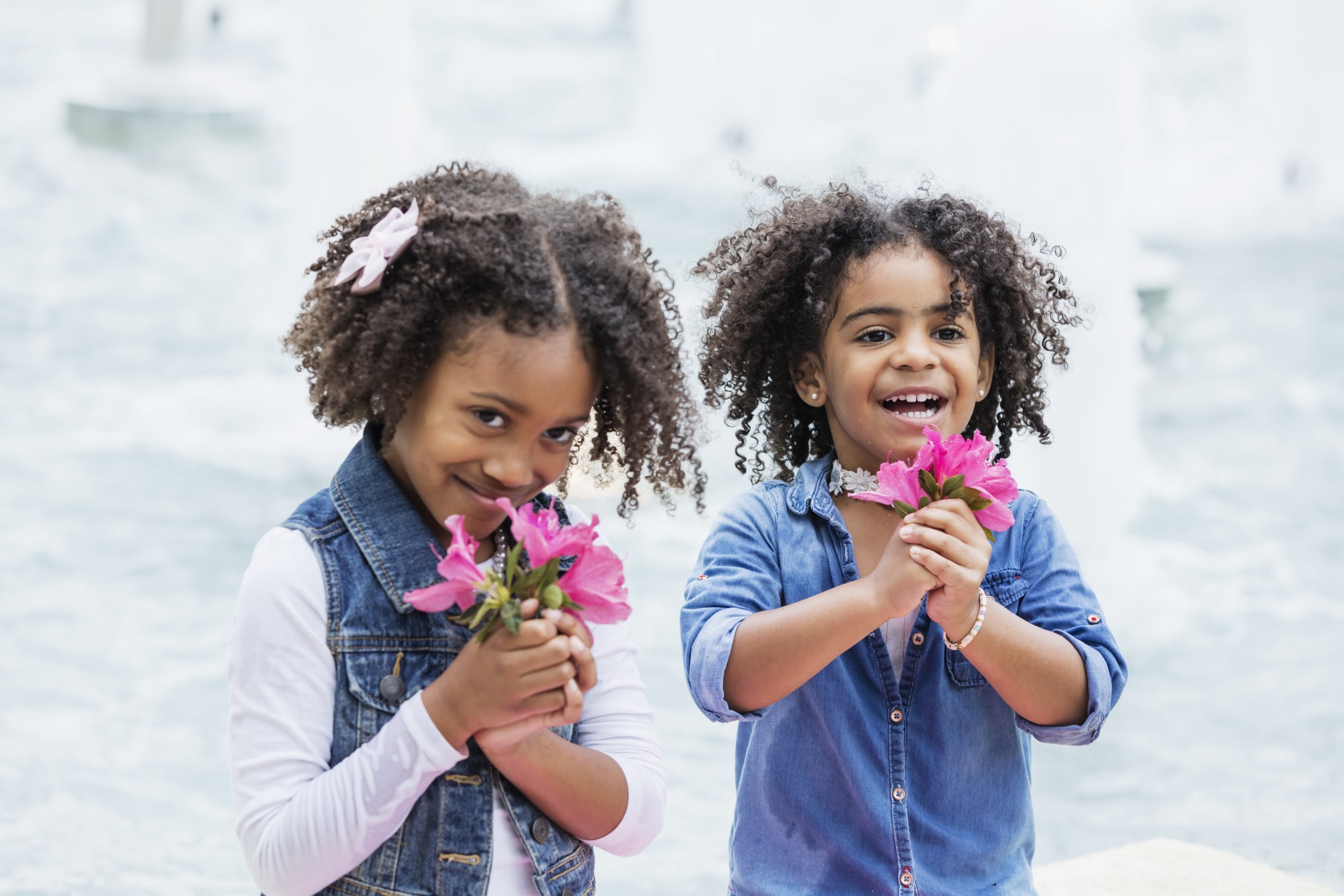 two young black girls with pink flowers